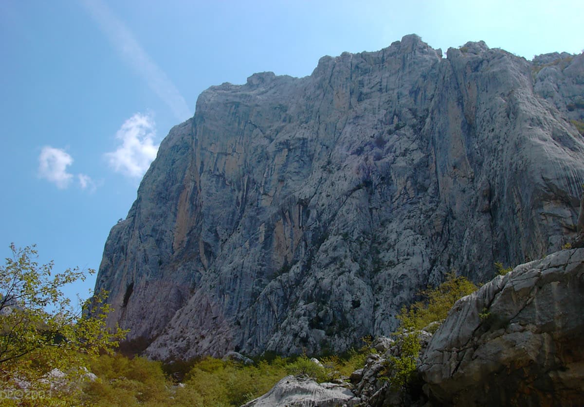 Anića kuk rising above the gorge, seen from below on the walk-in.