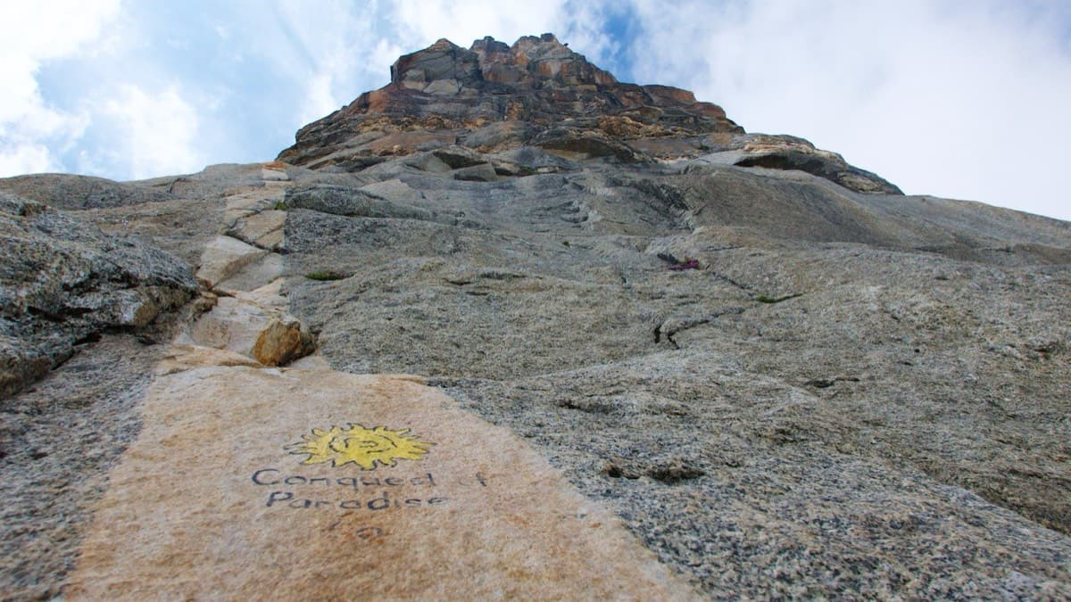 The start: 'Conquest of Paradise' and a yellow sun painted on the pale slab at the foot of the tower.