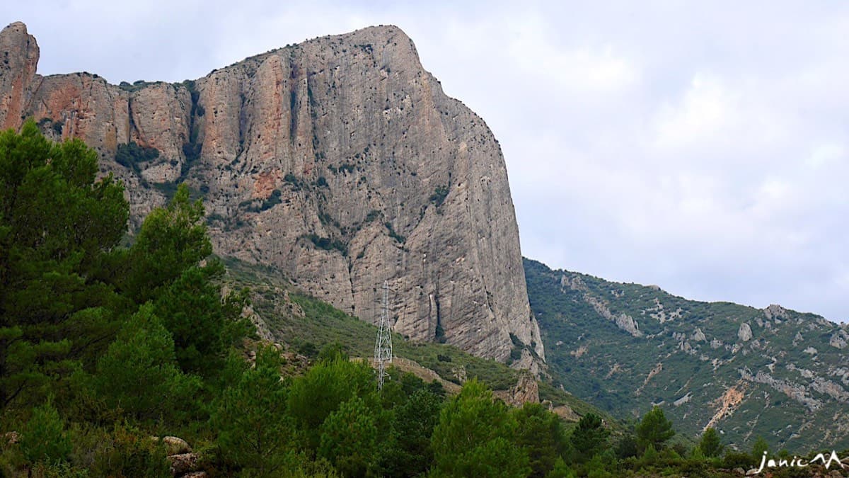 The east face of Peña Rueba and its spur seen on the walk-in, above the power-line pylon.