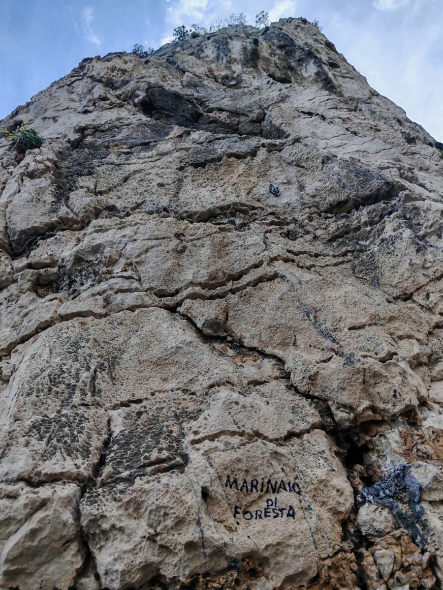 The route name painted in black at the foot of the first pitch.