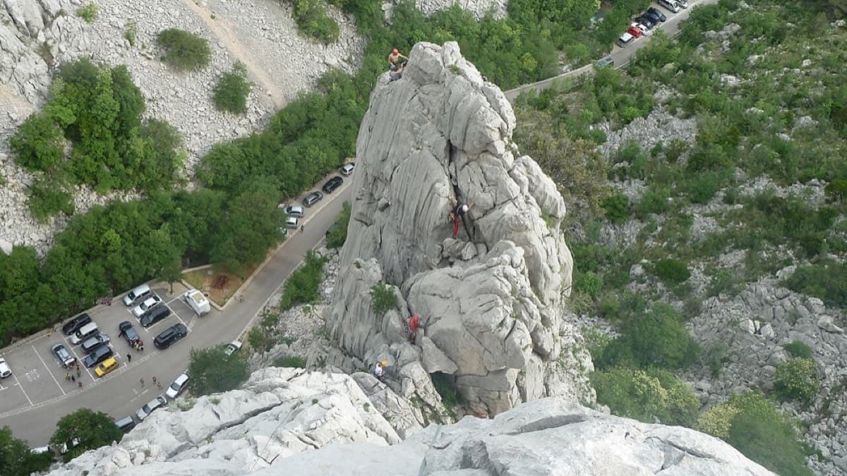 Looking down from the rocks above onto the car parks along the road in the Velika Paklenica gorge; the walk-in starts from the last car park at the end of the road.