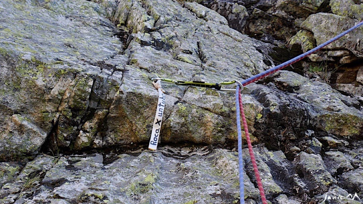 The first bolt with the small banner carrying the route name (October 2018; later reports say it has faded to white).