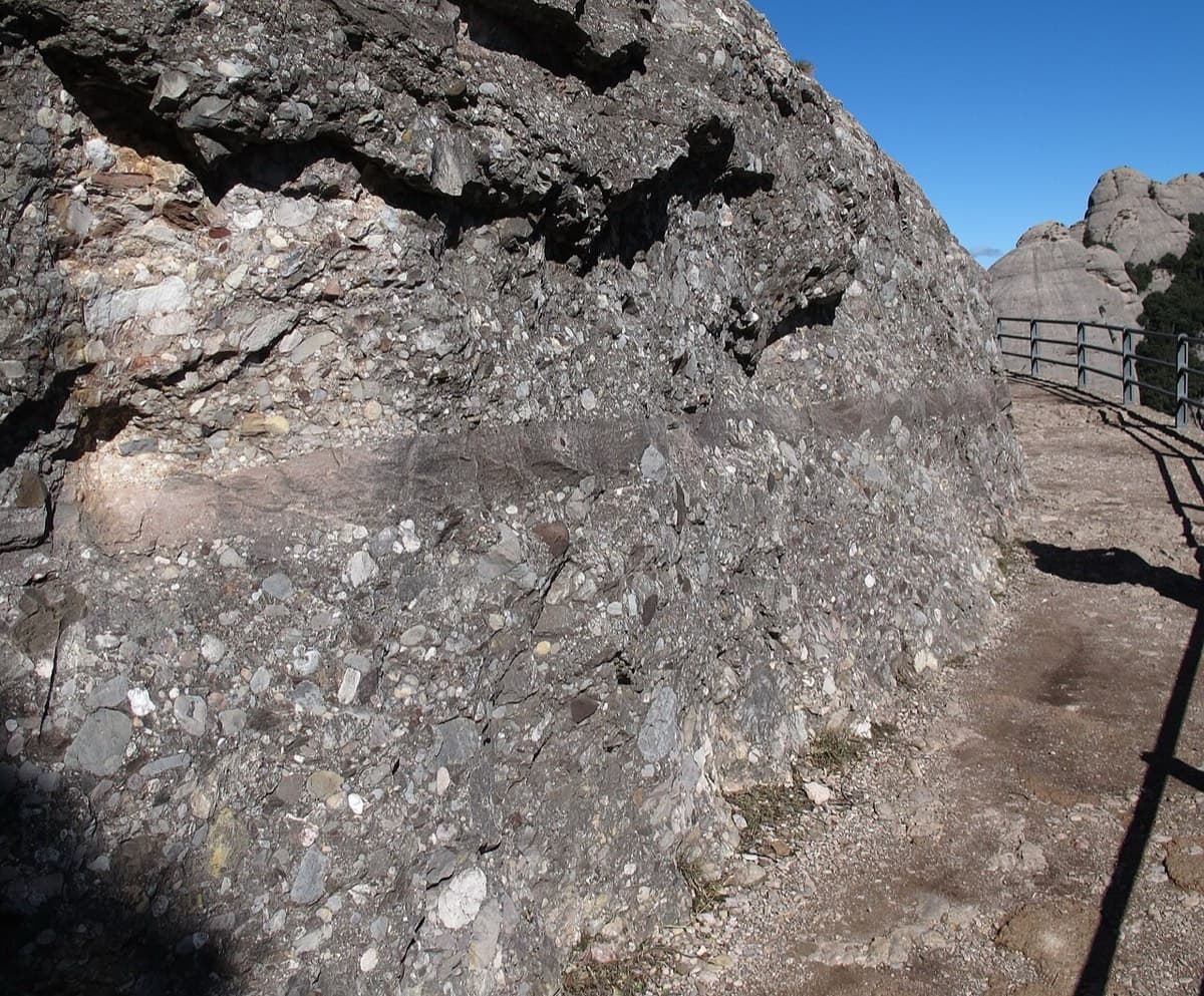 The railed Sant Jeroni path (Camí Nou) where it runs along the flank of the Gorra Frígia. Stay on it round the base of the tower; the gully leading to the start is on the left just after it.