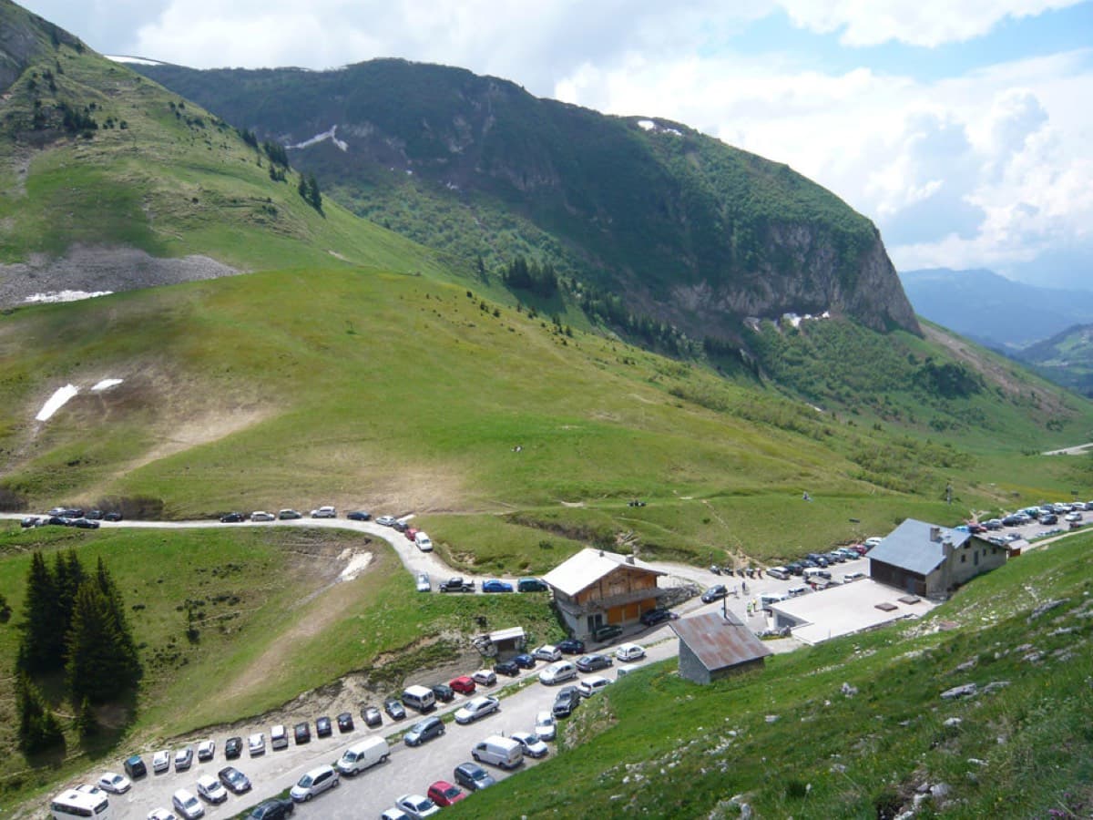 The busy car park at the Col de la Colombière seen from above; the route starts lower down, from the quarry at the second hairpin on the Grand-Bornand side.