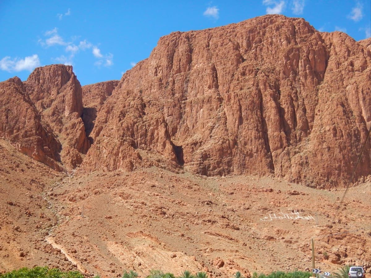 The Paroi du Levant seen from the village of Tizgui, with the stony slopes below it that the walk-in from the village crosses.