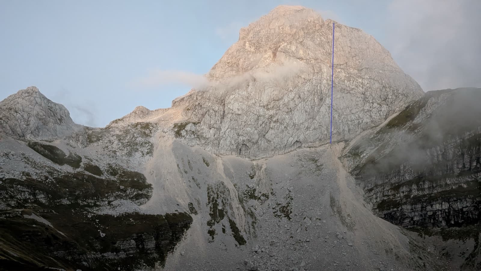 Mangart at first light from the saddle road, with the line of Briljantina drawn in blue.