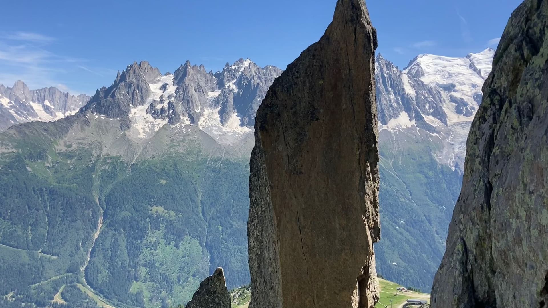 The pinnacle beside the abseil from the fifth belay on Cocher-Cochon, with the Chamonix Aiguilles and Mont Blanc across the valley
