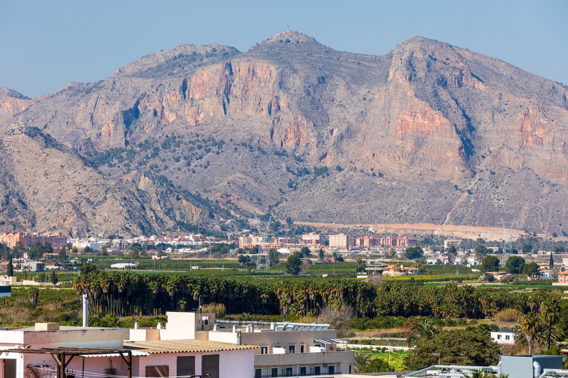 The south-east flank of the Sierra de Orihuela below the Cruz de la Muela, seen across the Vega Baja from Bigastro; Pared Negra is one of the walls on this flank (the exact wall is not marked).