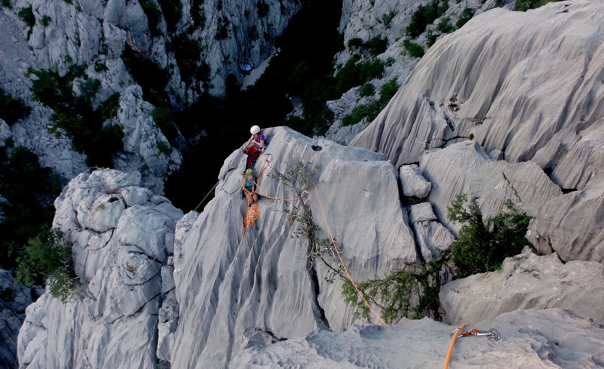 Giant water-worn flutes on Kuk od Skradelin: looking down from the top of Dreaming the Lost Friends to climbers at the last belay.