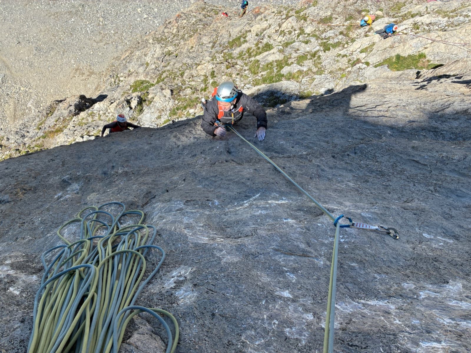 Following the fourth pitch (6b+) of Feu Sacré on the compact limestone of the Tour Termier.