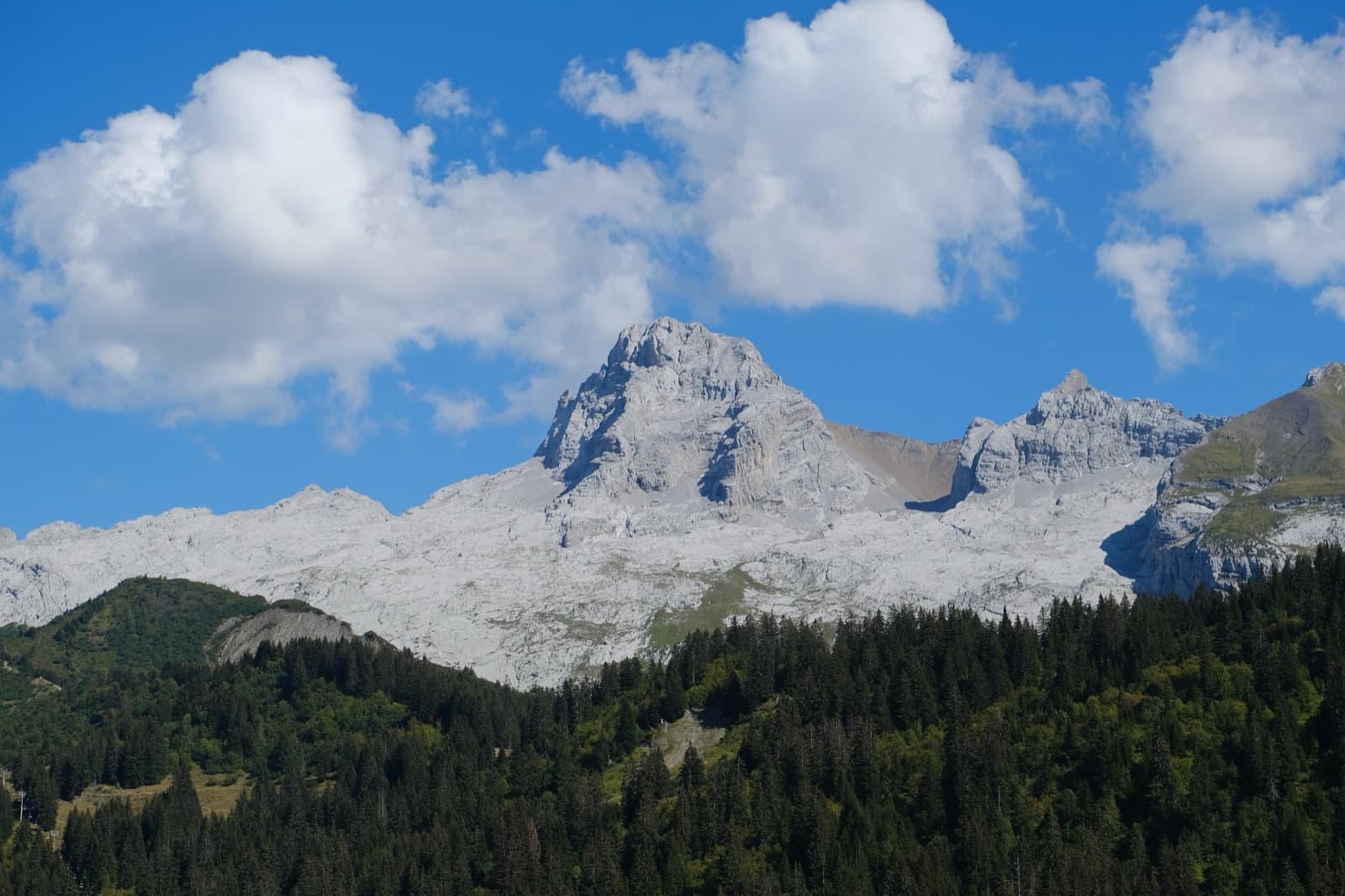 The Pointe Percée, highest summit of the Aravis, above its apron of pale limestone pavement, seen from the west near Le Grand-Bornand.