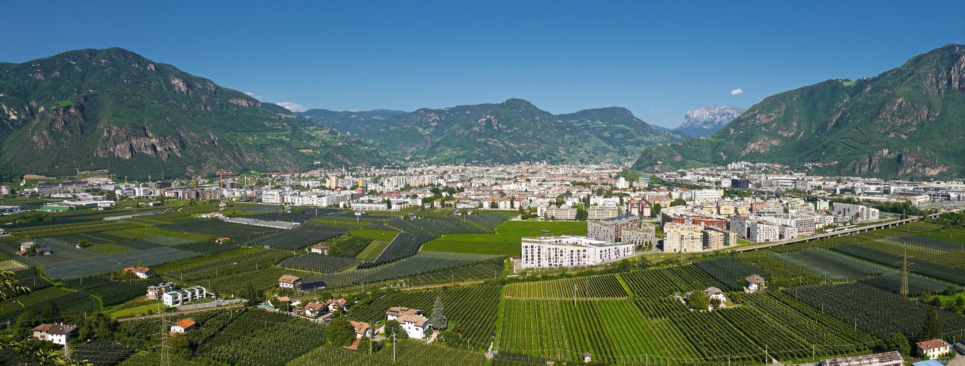 A view of the region, not this route's wall. The Bolzano basin seen from Sigmundskron castle, looking north-east.