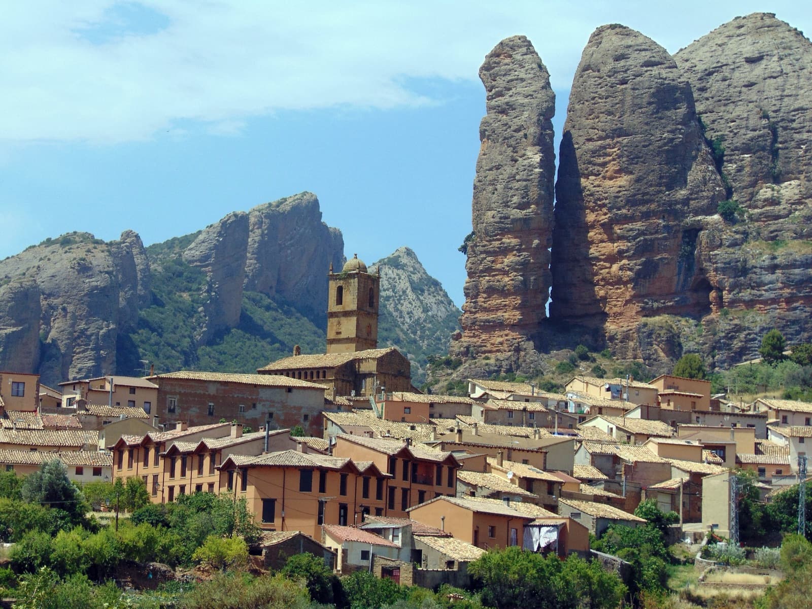 The village of Agüero and its church beneath the western end of the mallos and the tower of Peña Sola.