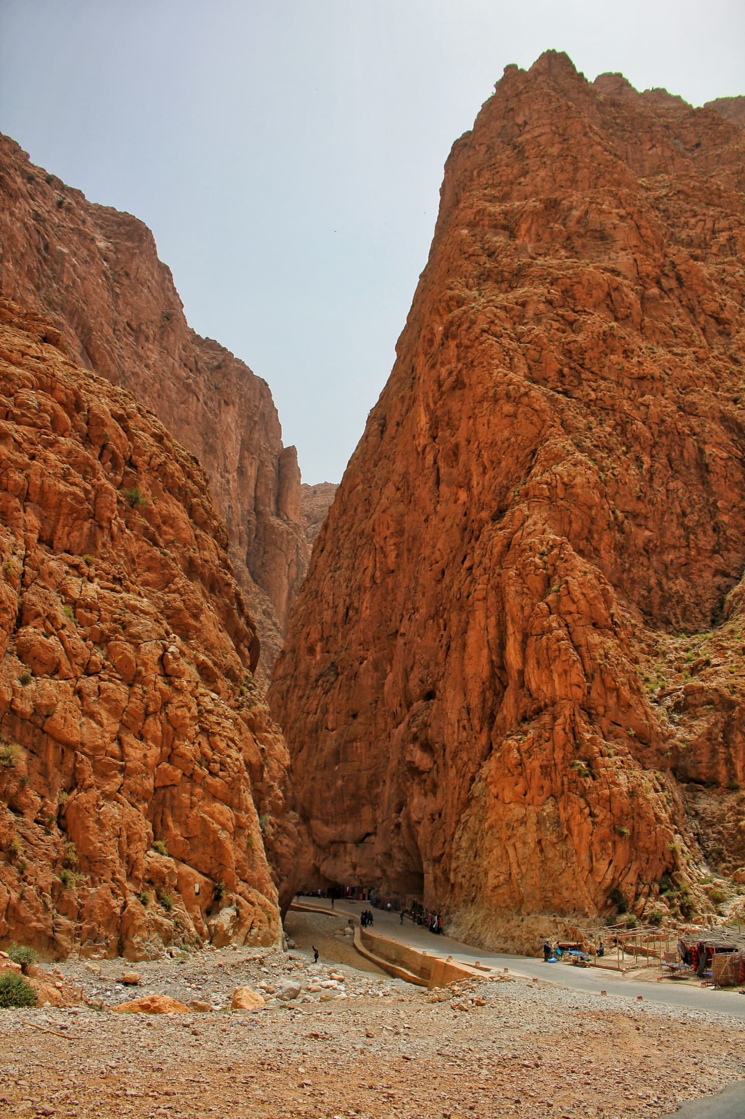 The upstream mouth of the Todra narrows: the road disappears into the slot and the great prow rising on its right is the Arête Nord.