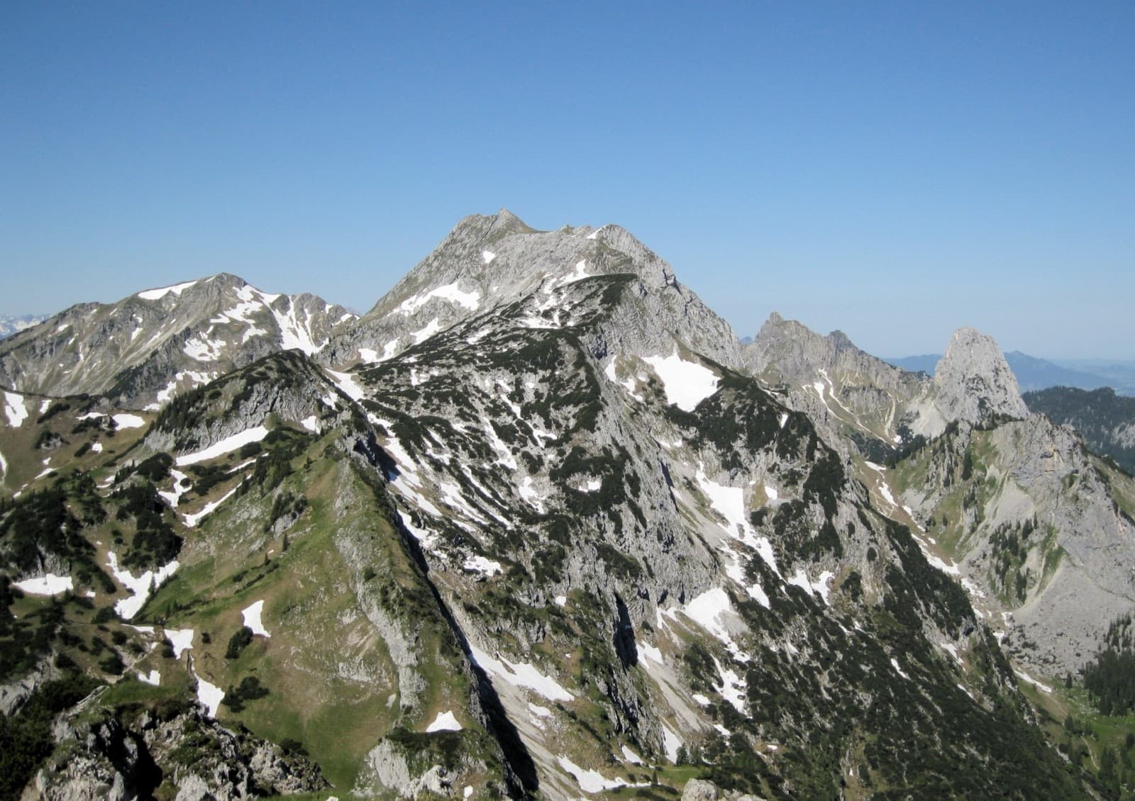 A view of the region, not this route's wall. The Hochplatte in the Ammergau Alps seen from the east in early summer; the Schlössel crag is on this side of the massif but cannot be picked out.