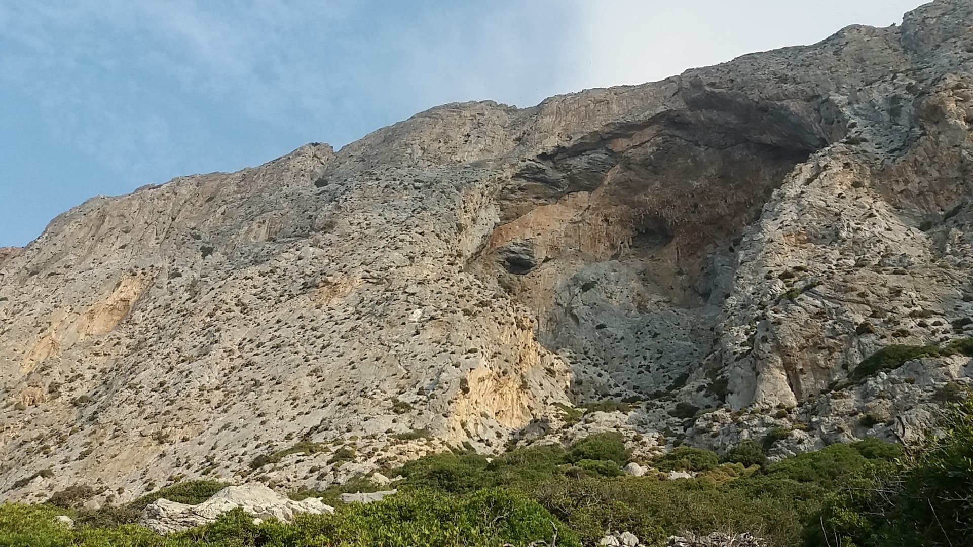 The south face of Telendos and its great cave, seen from the approach.