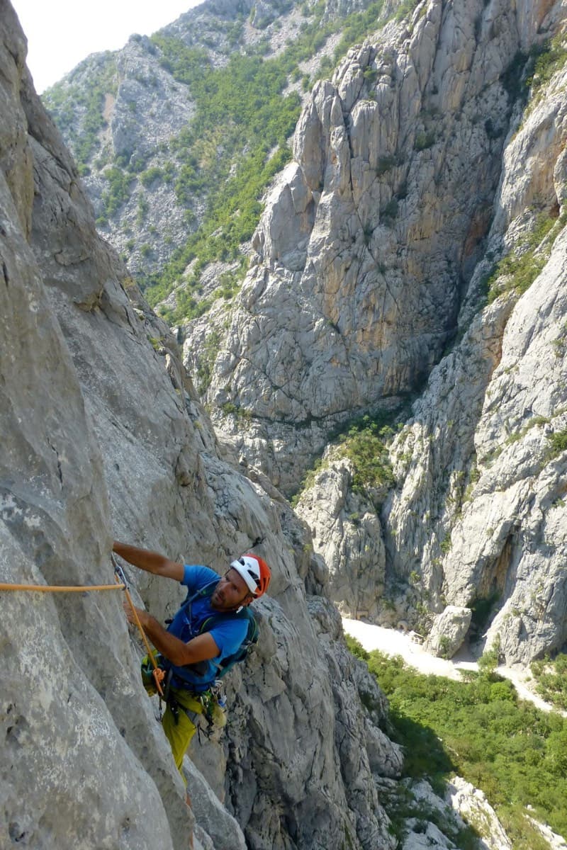 Climber on Water Song, Veliki Ćuk, with the Paklenica gorge behind