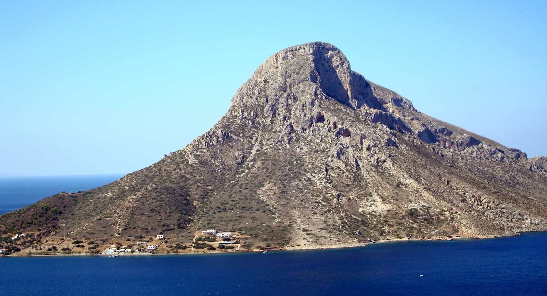 Telendos seen from Myrties on Kalymnos; the south face routes are on the steep left-hand side of the mountain above the village