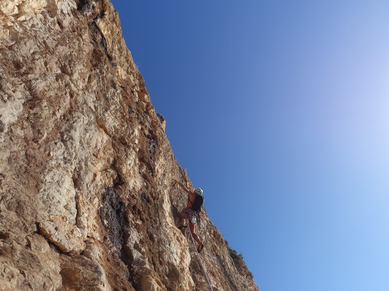A climber on the steep crux wall of Silberrücken, Morro Falquí