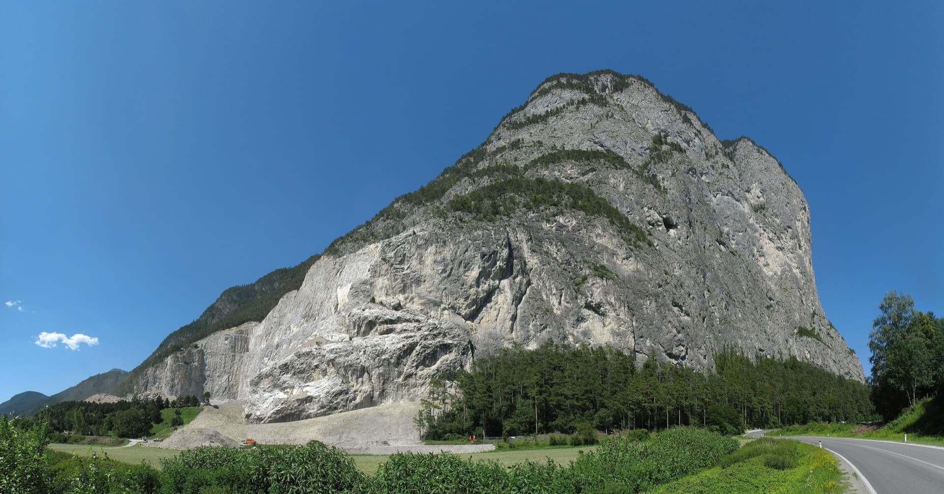 The Martinswand above the Inn valley near Zirl, seen from the south-west. The Vorbau routes climb the slabby plinth at the right-hand (eastern) end of the wall; the line is not marked.