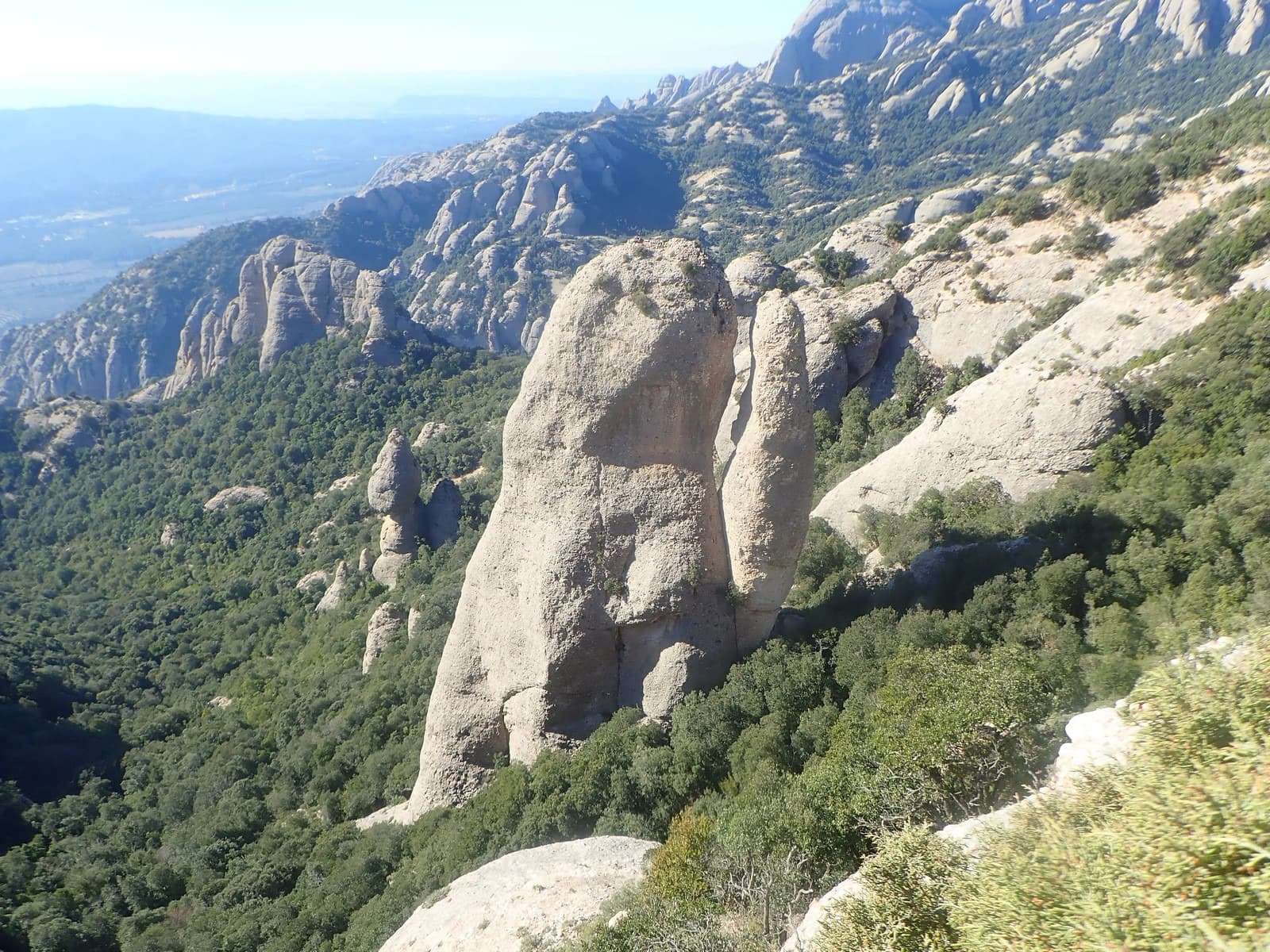 The Sentinella needle and the south side of Montserrat, photographed from the Cara de Mico during an ascent of the neighbouring Via Infidel. The approach passes the foot of the Sentinella.