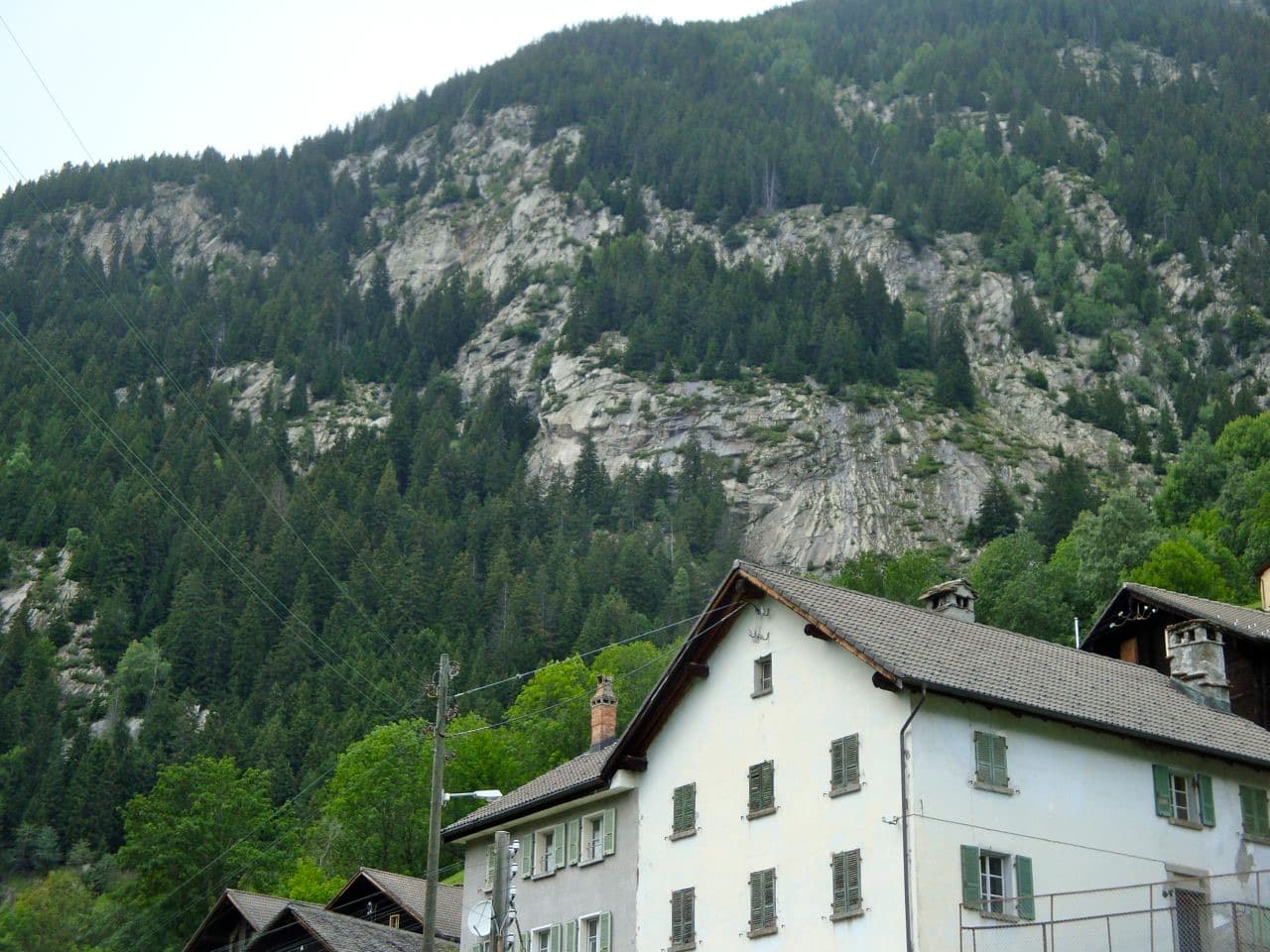 The gneiss slabs of the Placche di Freggio rising through the forest above the hamlet of Freggio