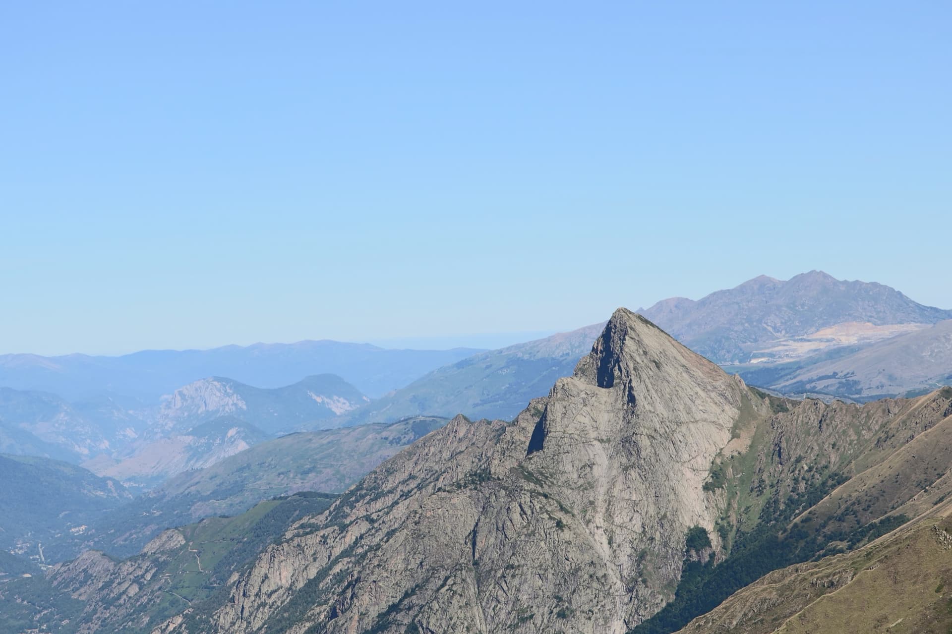 The Dent d'Orlu (2222 m), the granite tooth whose slabby flanks hold the long bolted routes of the Orlu valley