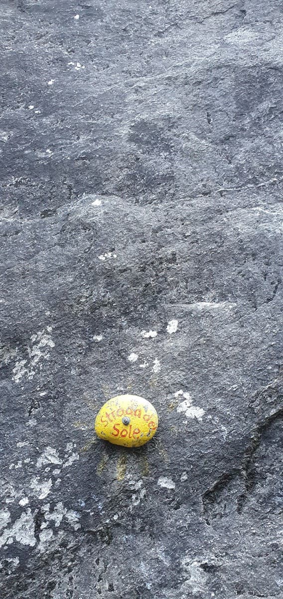 A view of the region, not this route's wall. The painted stone that marks the start of Strada del Sole at the foot of the Nösslachwand