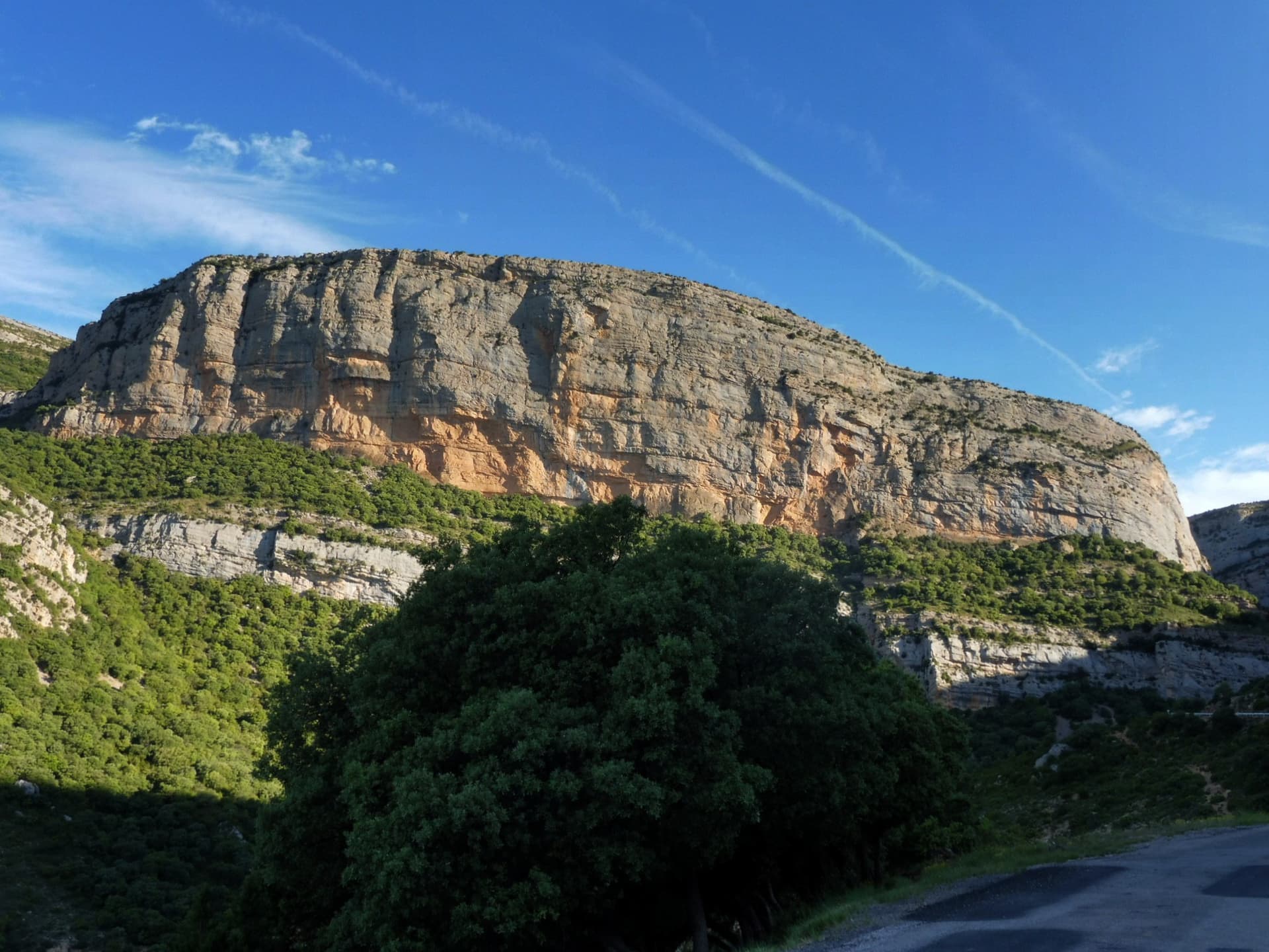 A view of the region, not this route's wall. The south-east face of the Roca dels Arcs above the road from Vilanova de Meià, in the Montsec de Rúbies.
