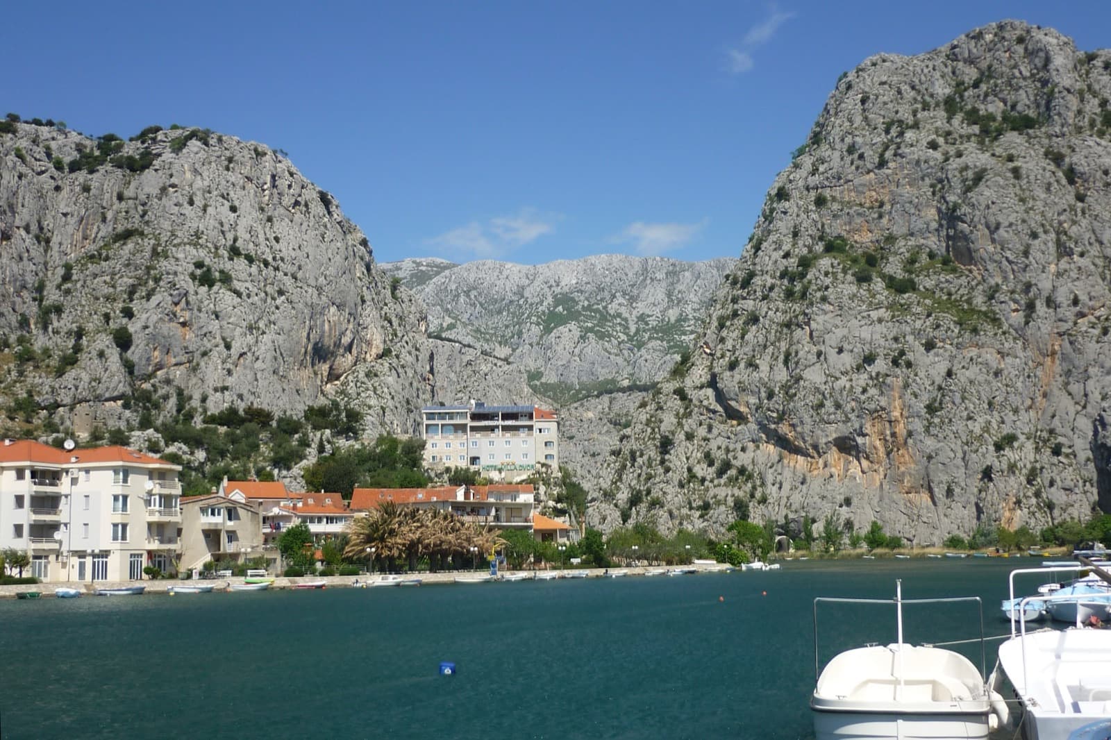 A view of the region, not this route's wall. The limestone gate of the Cetina at Omiš, seen across the river mouth; the town's crags, Stomorica among them, are on cliffs like these.