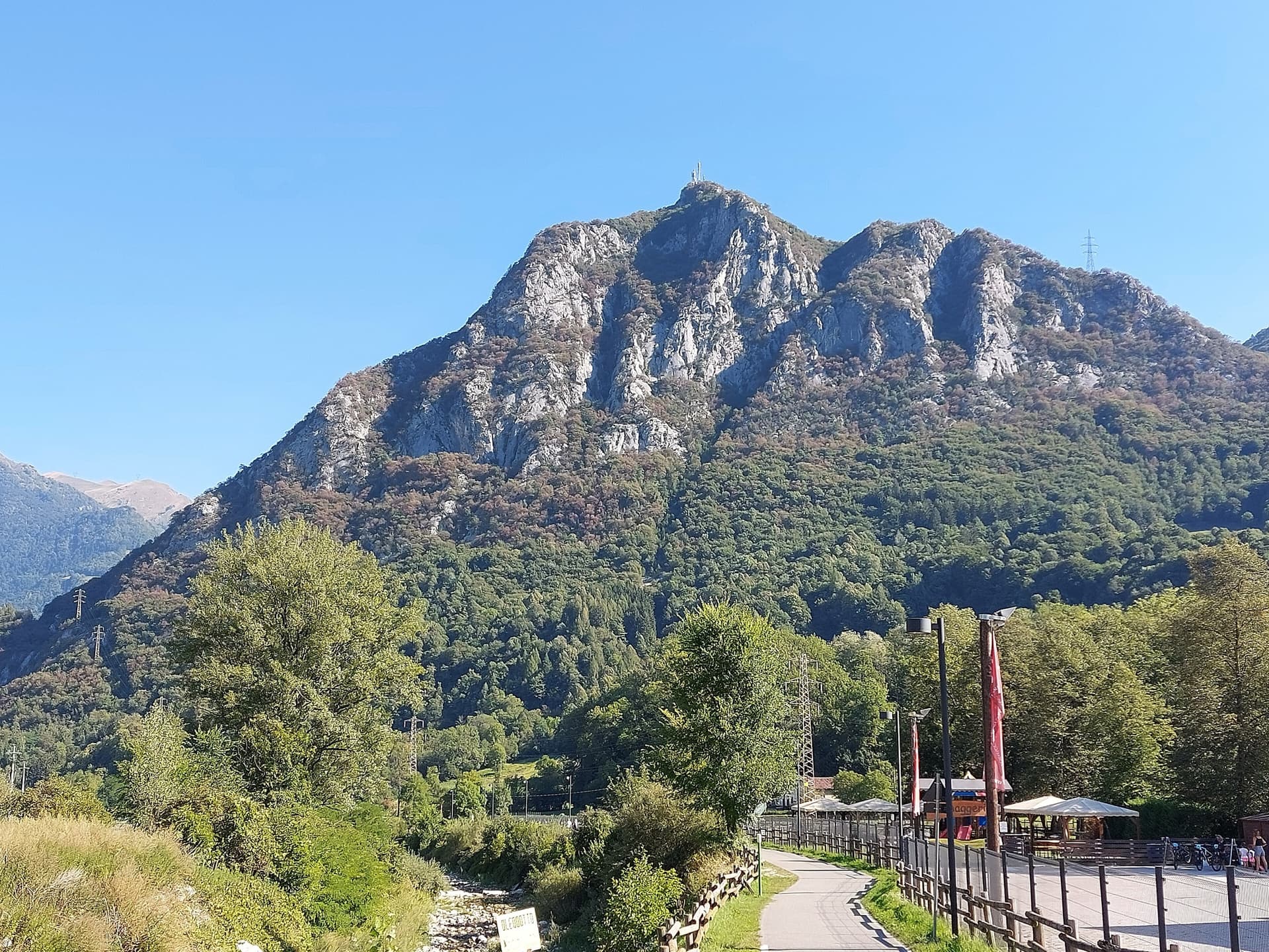 The Zucco dell'Angelone above the Valsassina, seen from Pasturo, with the antenna on its summit. The climbing spurs are the pale limestone ribs on the sunny side of the mountain above Barzio; individual spurs and routes are not marked.
