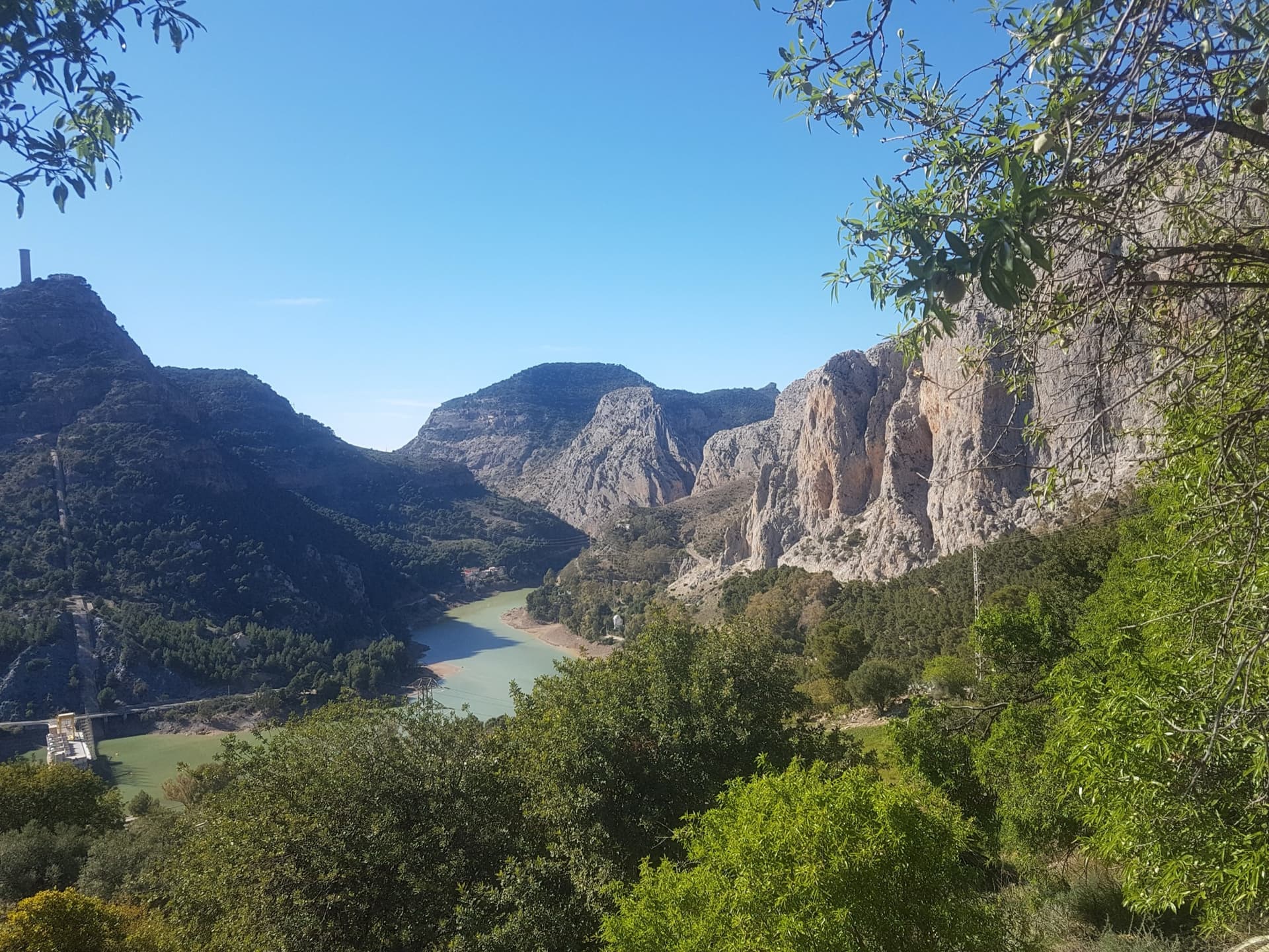 El Chorro: the reservoir and the limestone walls above it, seen from the hillside. A general view of the area; the route is not marked.