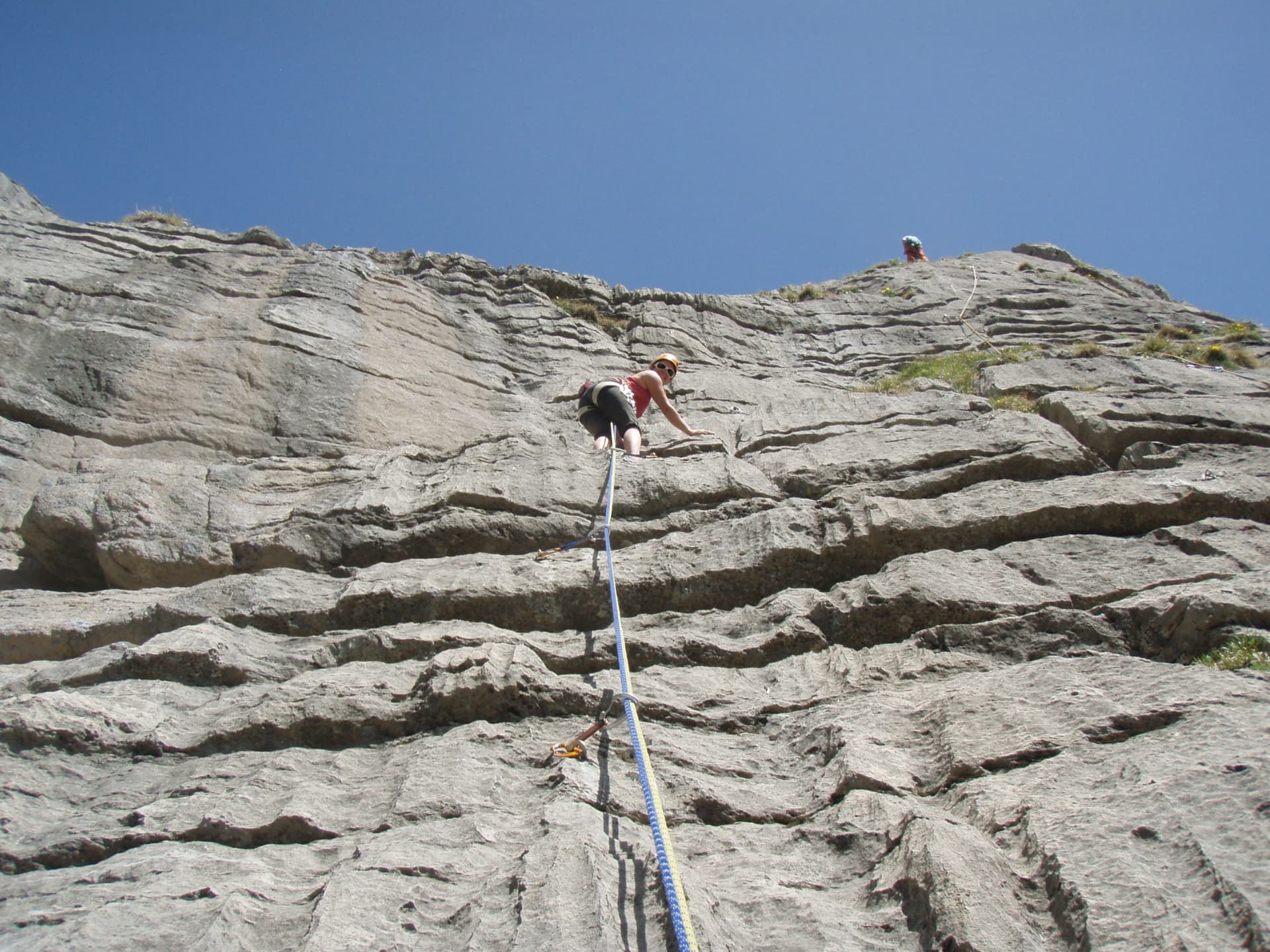 Climbers on the first pitch of the Familienroute, Ueschenen, on runnelled grey limestone