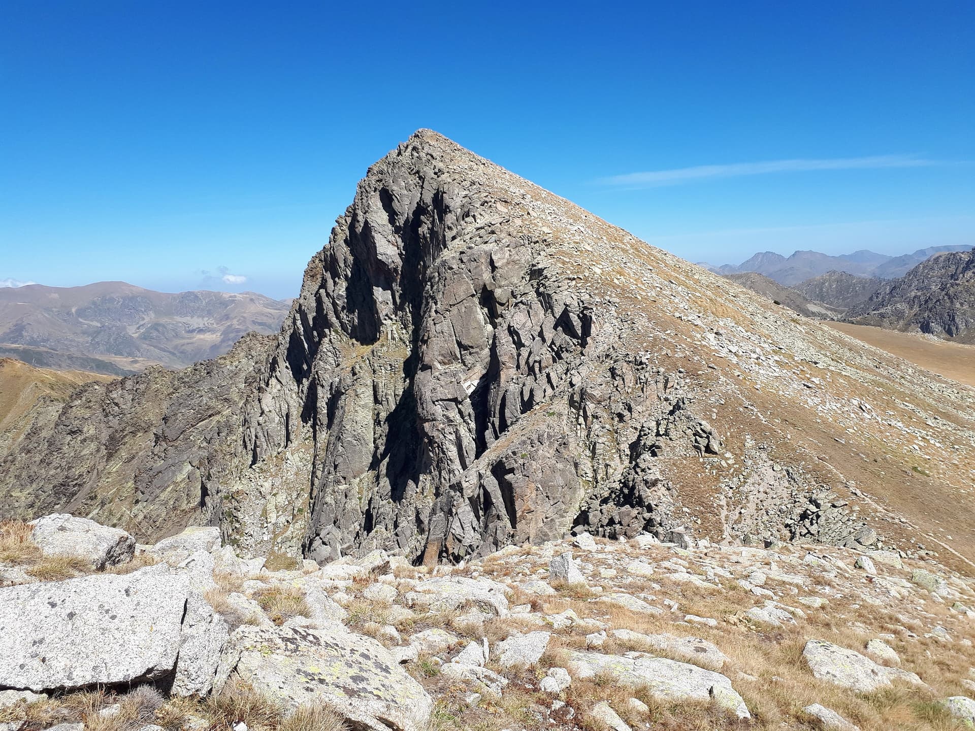 The rocky summit pyramid of the Pic Negre d'Envalira from the south in September.