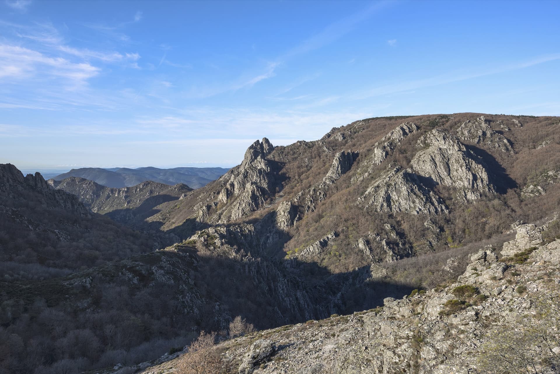 Gneiss ridges and towers above the Gorges d'Héric, the deep cleft on the western side of the Caroux massif, in spring.