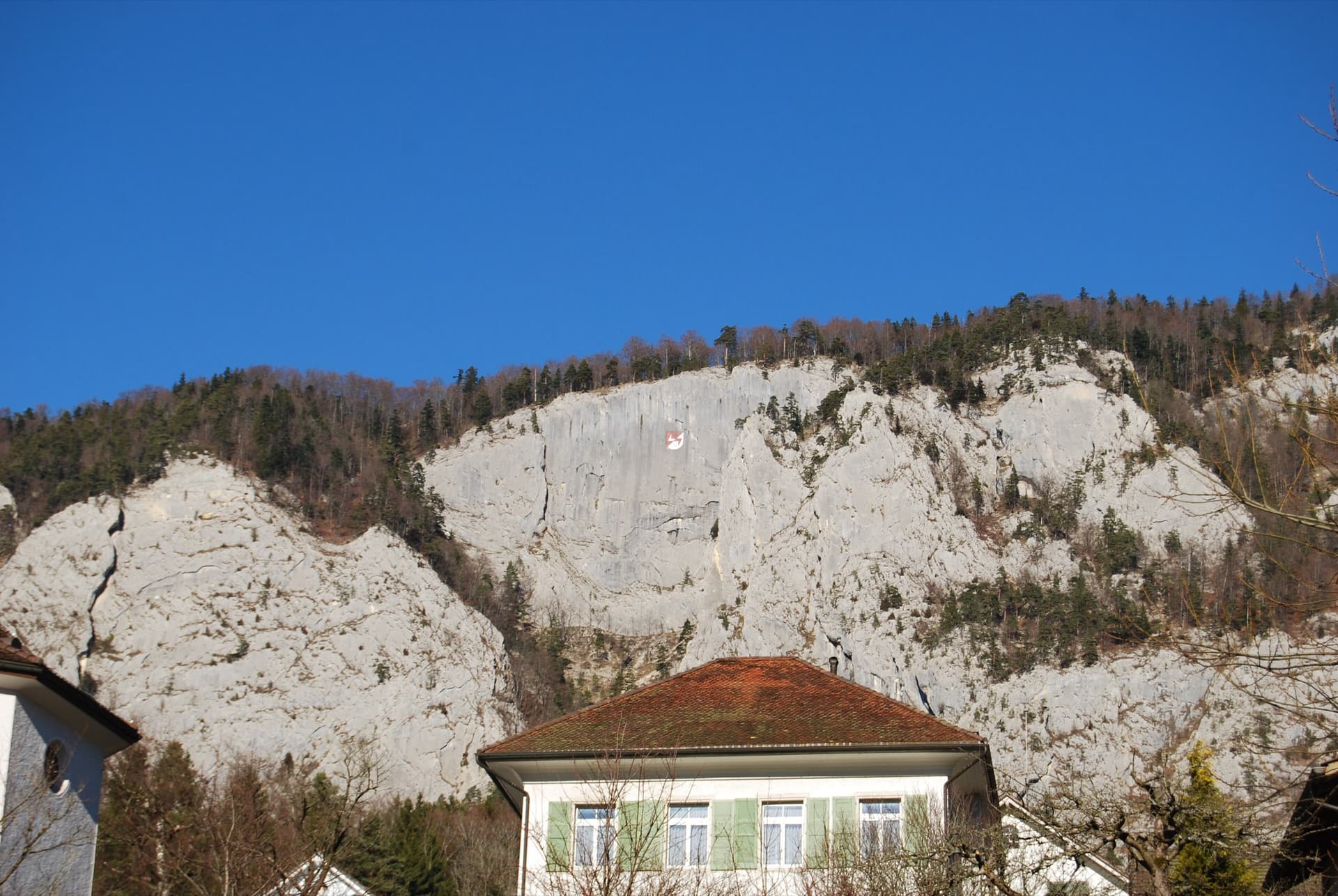 The Glatti Flue above Welschenrohr, with the village coat of arms painted on the limestone.