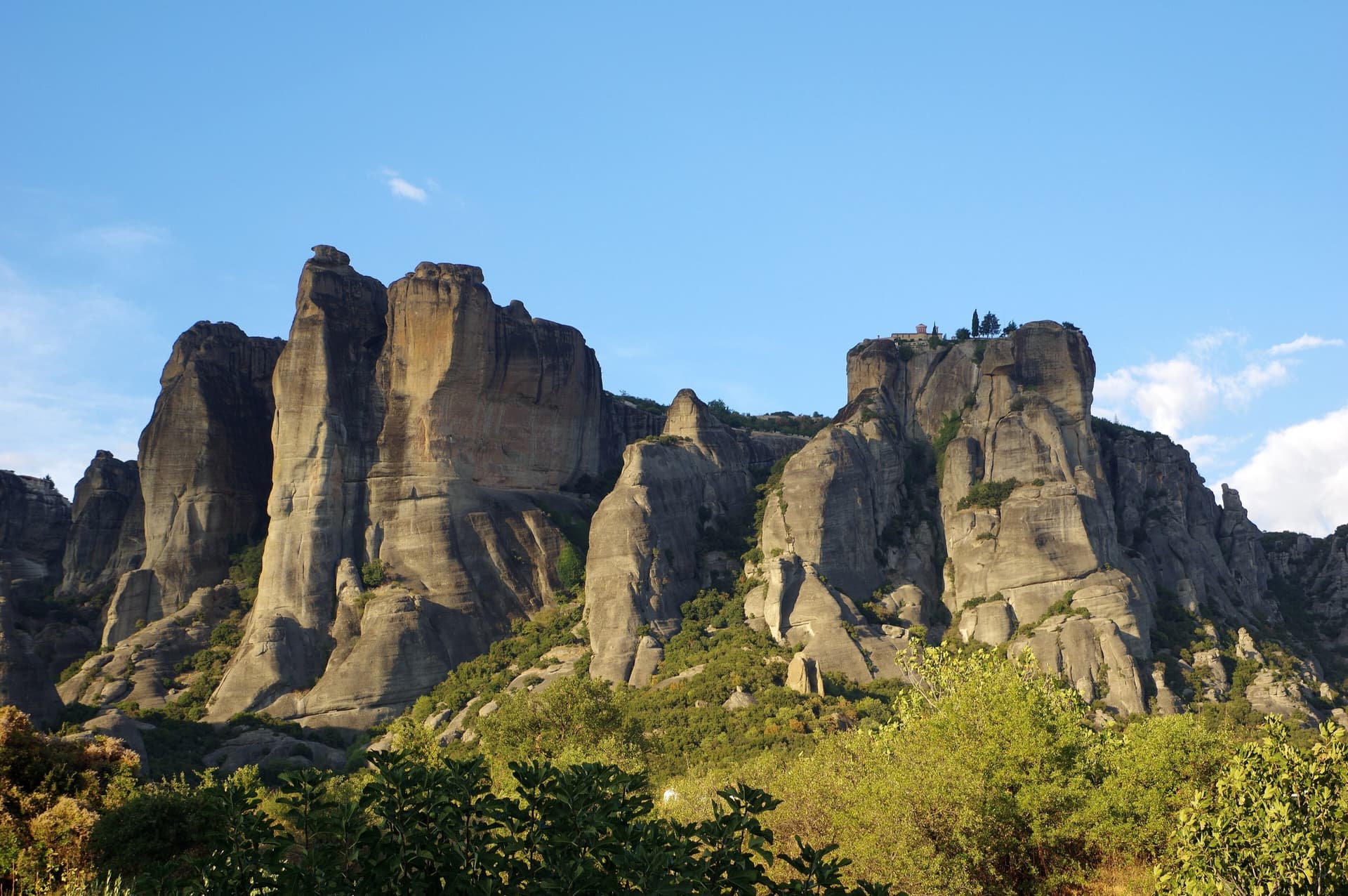 Meteora towers in evening light seen from Kalambaka, with the monastery of Agios Stefanos on the rock at right.