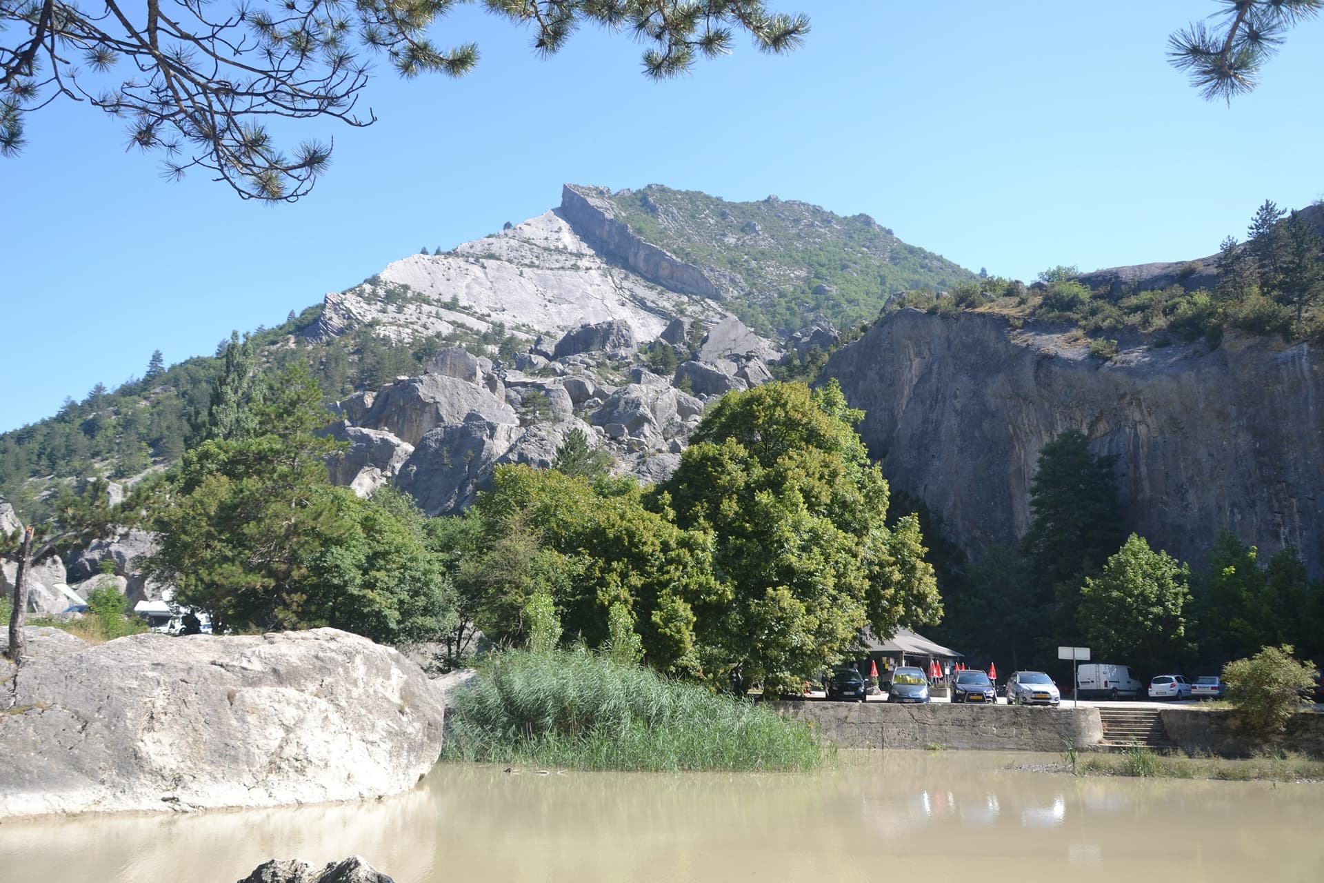 The tilted grey slab of the Pic de Luc above the boulder chaos of Le Claps and the Drôme near Luc-en-Diois.