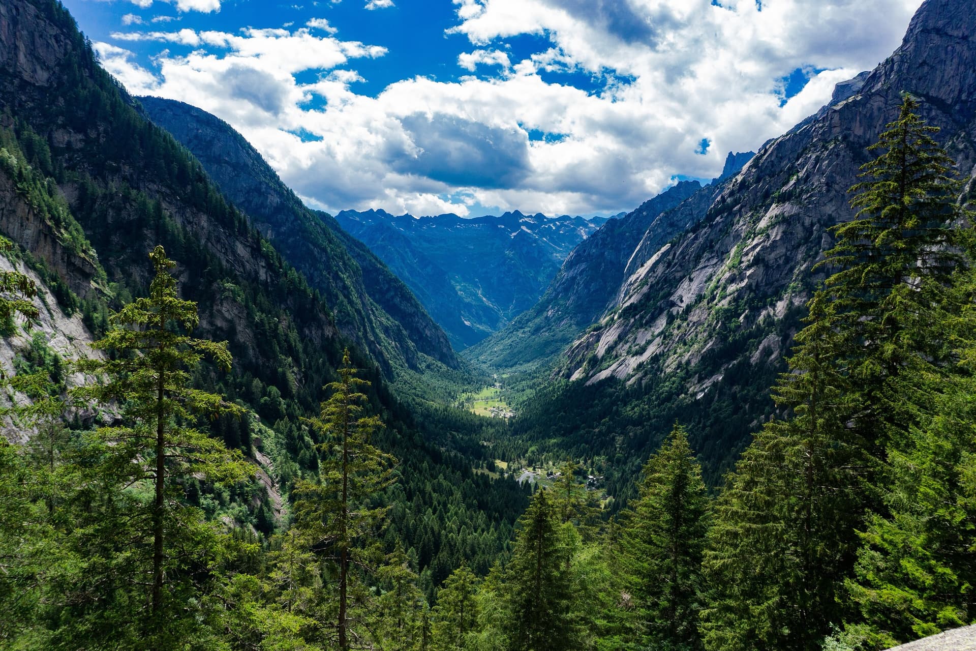 Val di Mello in Val Masino from a balcony path, with granite slabs and walls on both sides of the valley.